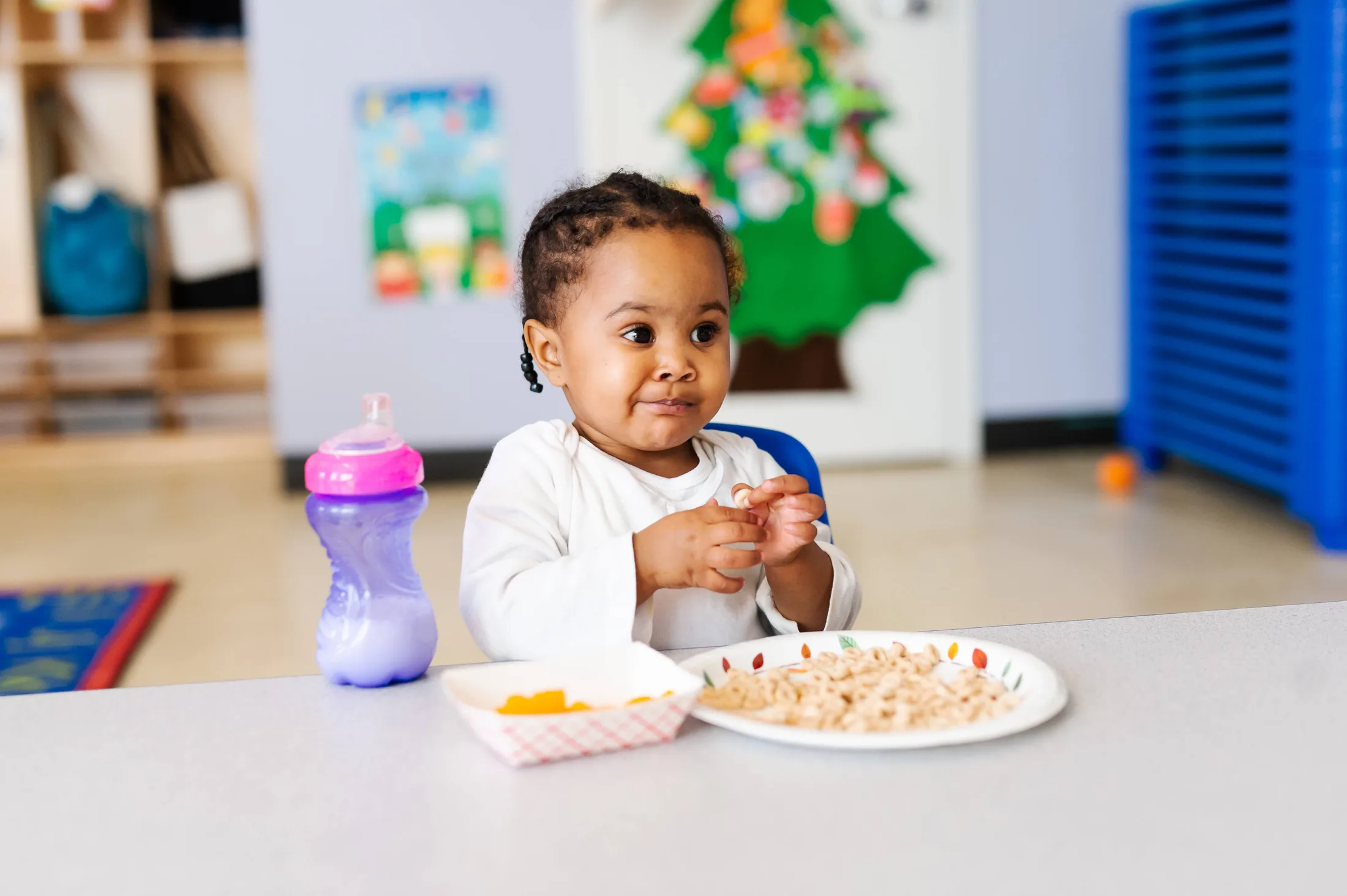 An educator supporting a young child in an early learning setting